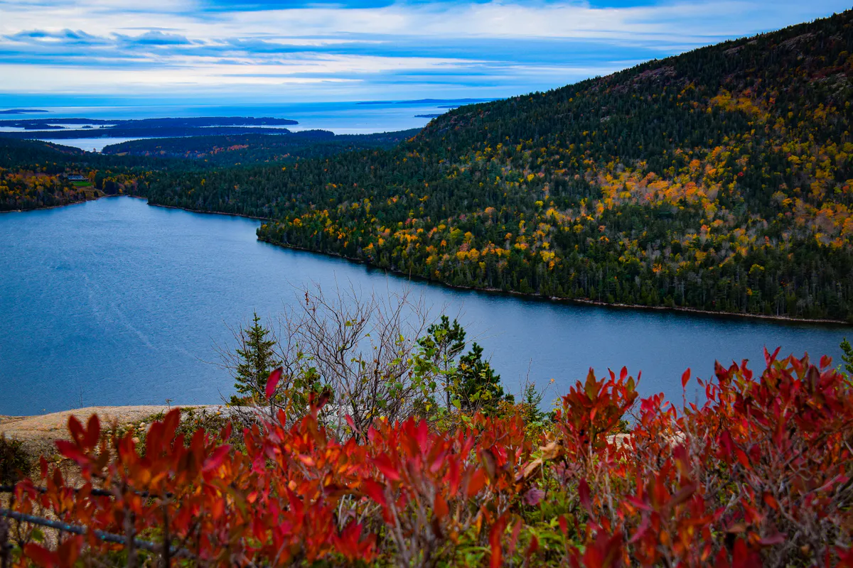 View of Jordan Pond from South Bubble Rock Trail with the Bubbles mountains rising from the water in Acadia National Park