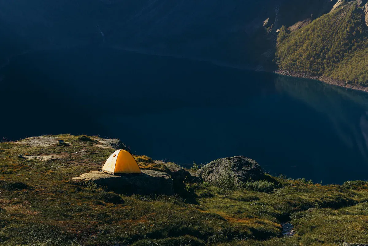 Tent overlooking a mountain lake at dawn